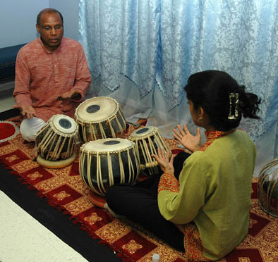 Chris Pereji playing tabla drums., North Indian tabla, 2009; South Attleboro, Massachusetts; Photography by Maggie Holtzberg